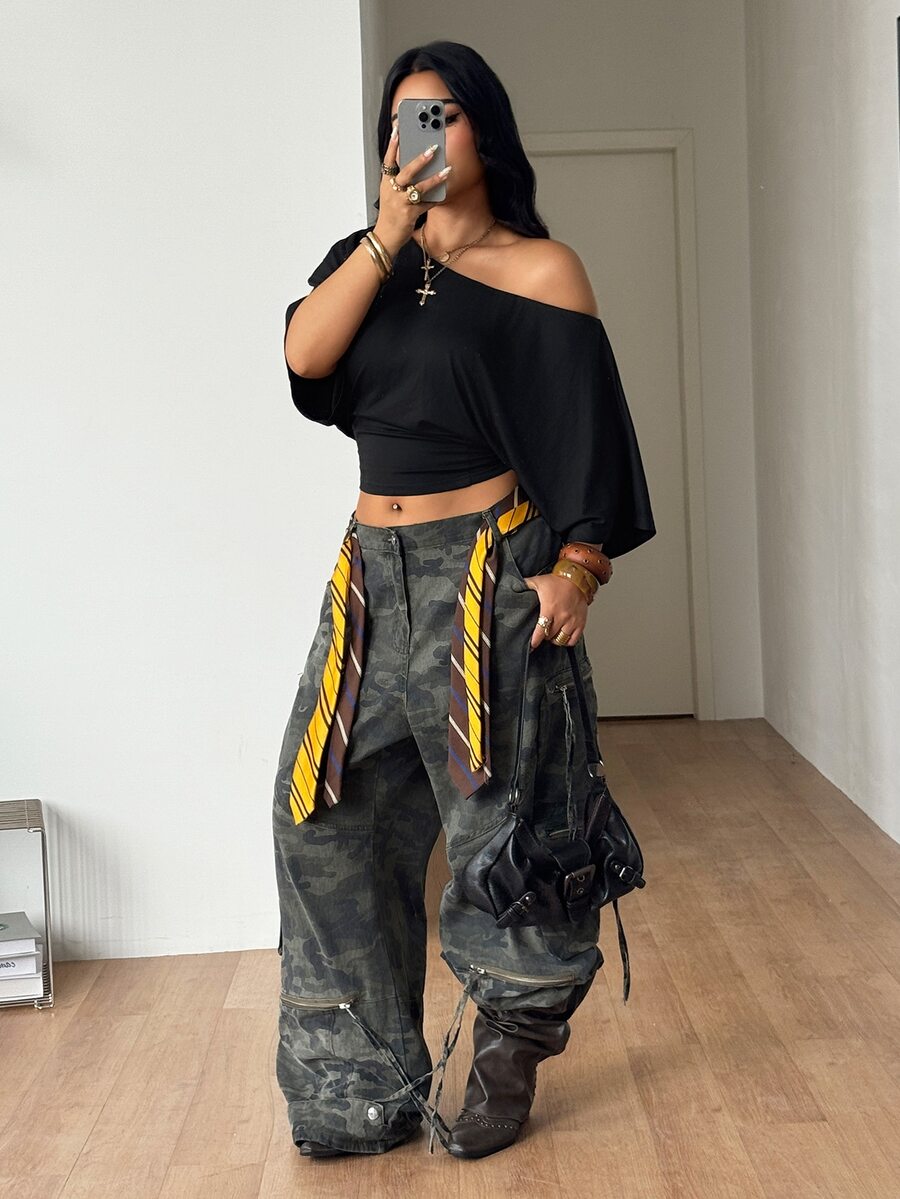Black plus size cropped knit t-shirt featuring an asymmetrical scoop neckline, three-quarter batwing sleeves, and a loose casual fit.