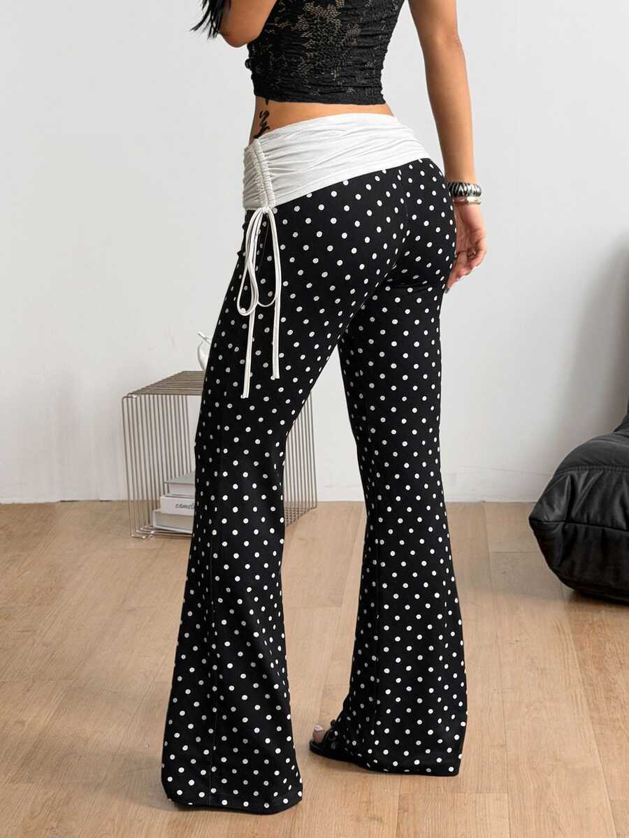 Women's black and white polka dot flare leg pants with side drawstring and ruched details