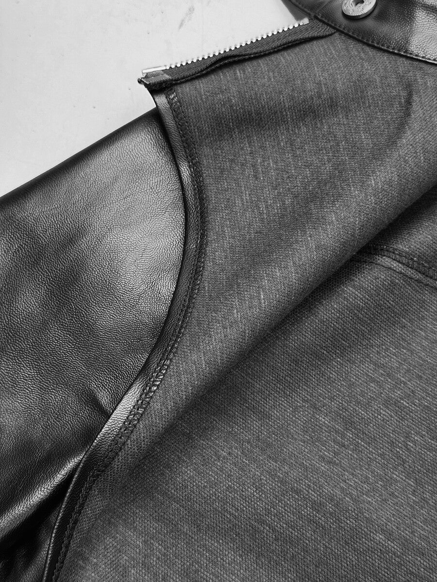 Front view of women's black cropped PU leather jacket featuring an asymmetrical hem, stand collar, and zipper hardware details.