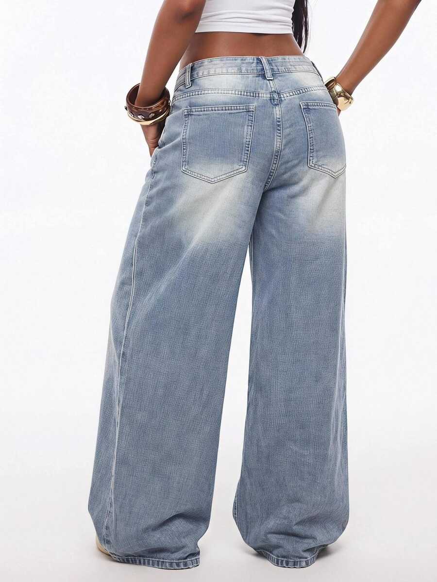 Loose wide leg denim jeans for women featuring a low waist, functional pockets, zipper fly closure, and extra long relaxed fit.