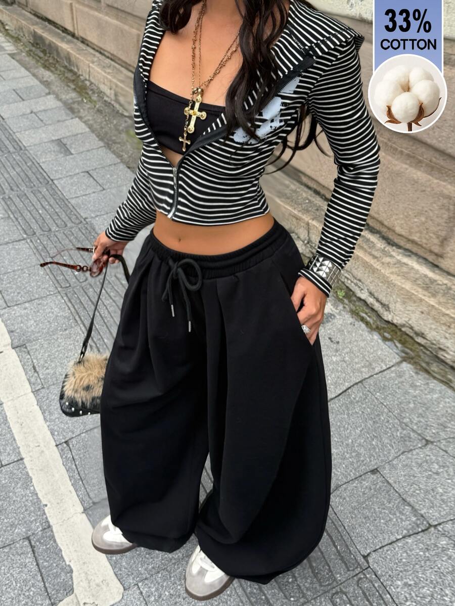 Women's casual black loose fit baggy banana pants featuring a low rise elastic drawstring waist and side pockets.