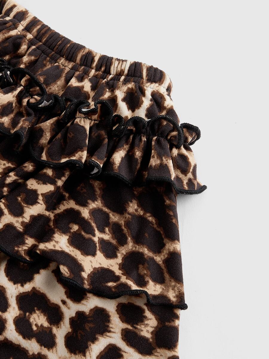 Women's low waist tiered mini skirt featuring ruffled hem layers in knitted stretch fabric.