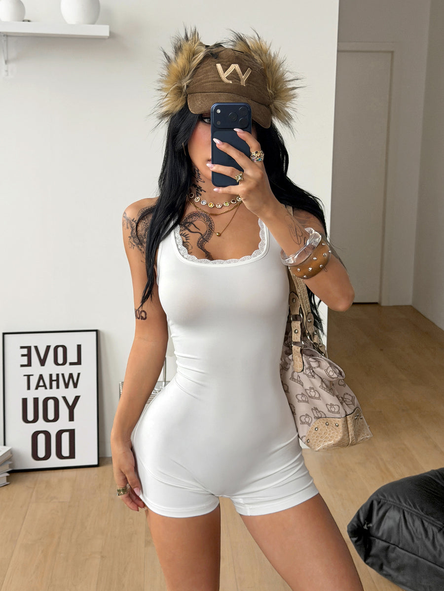 Women's black sleeveless unitard romper with a square neckline and backless design in stretchy knitted fabric.