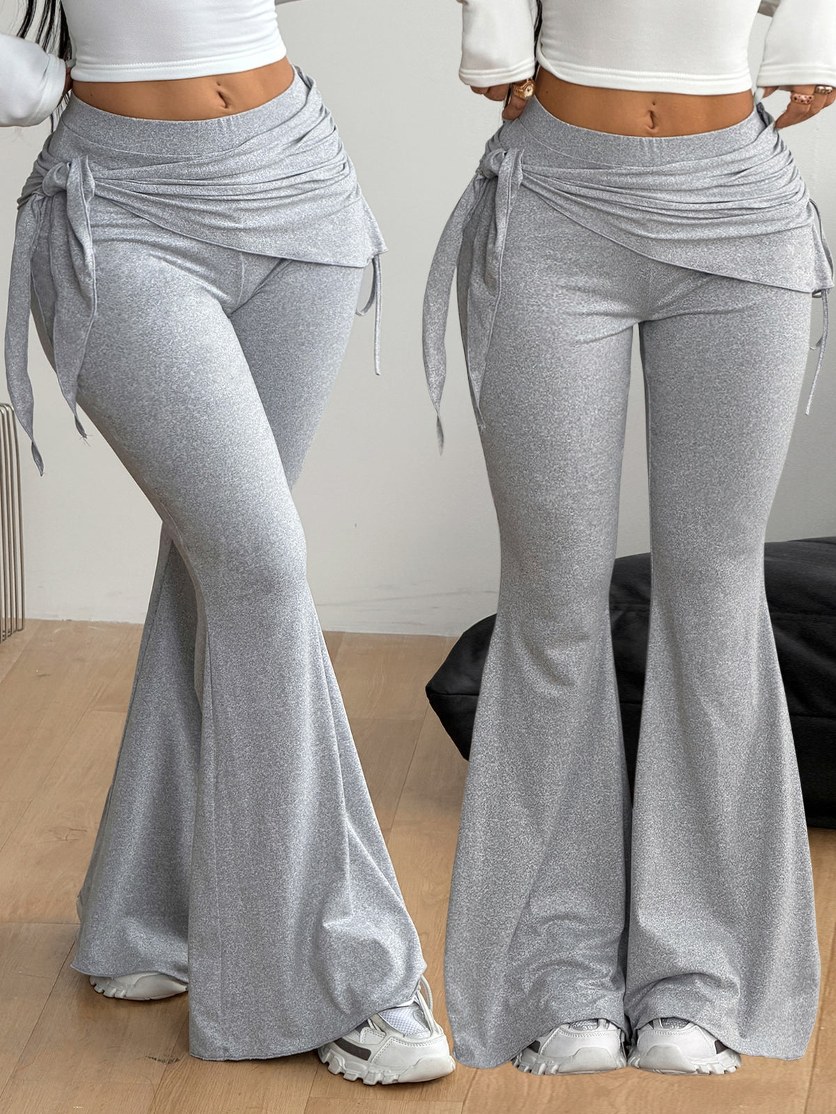Women's black low rise flare pants with split hem detailing and stretchy knit fabric