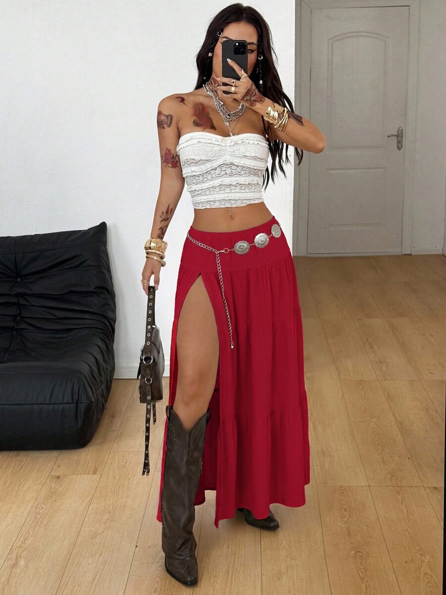 Women's red plaid long skirt featuring a low-rise waist and a side slit in lightweight woven fabric.