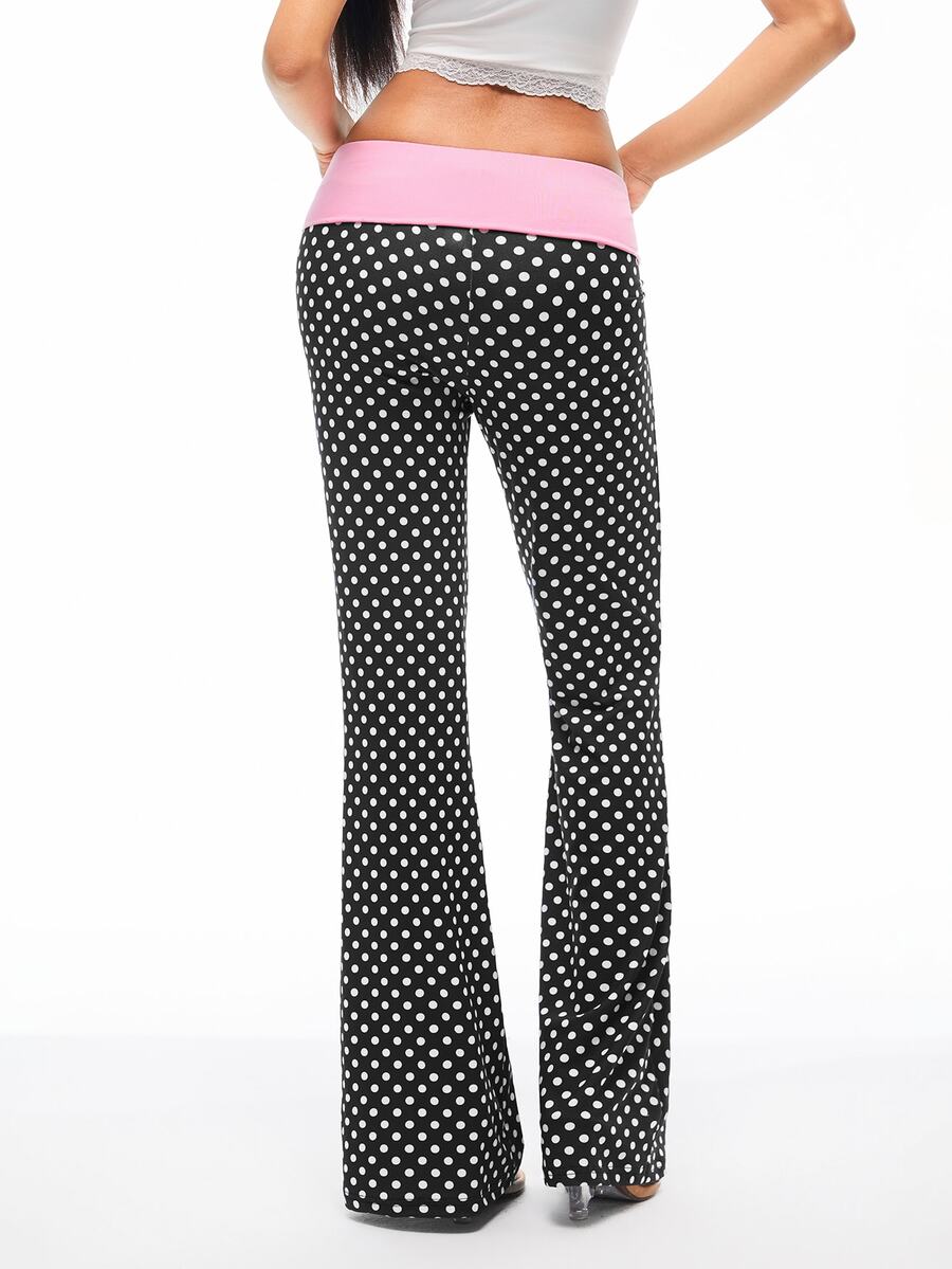Women's black and white polka dot flare leg pants with side drawstring and ruched details