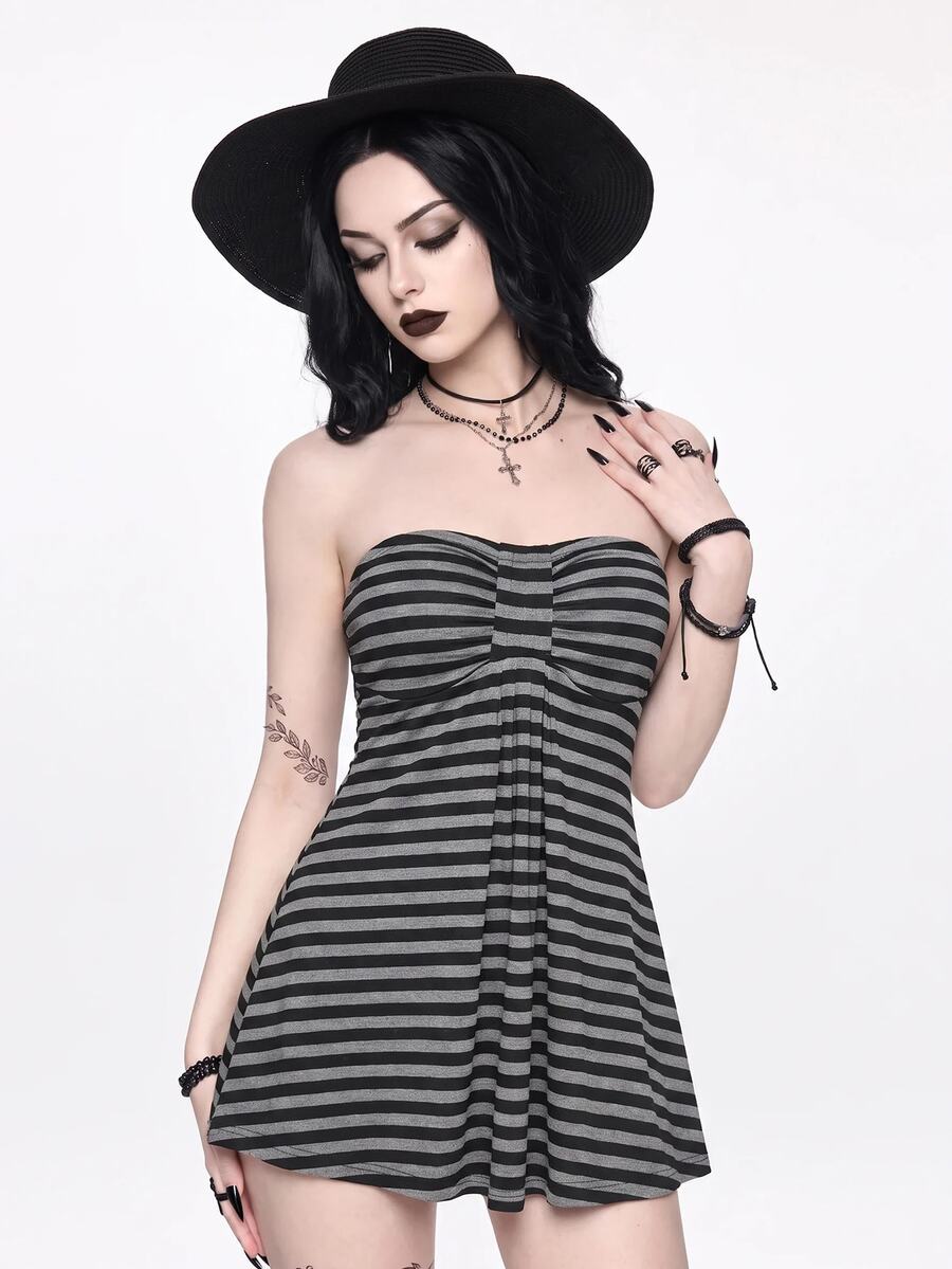 Women's striped strapless tube top featuring ruched detailing, flared hem, and stretchy knit fabric.