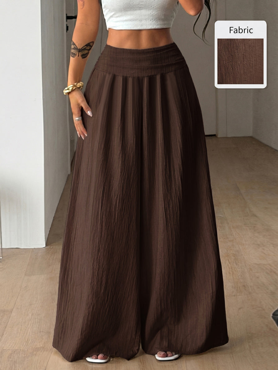 Women's plus size high-waist pleated wide leg pants in textured woven fabric with pockets