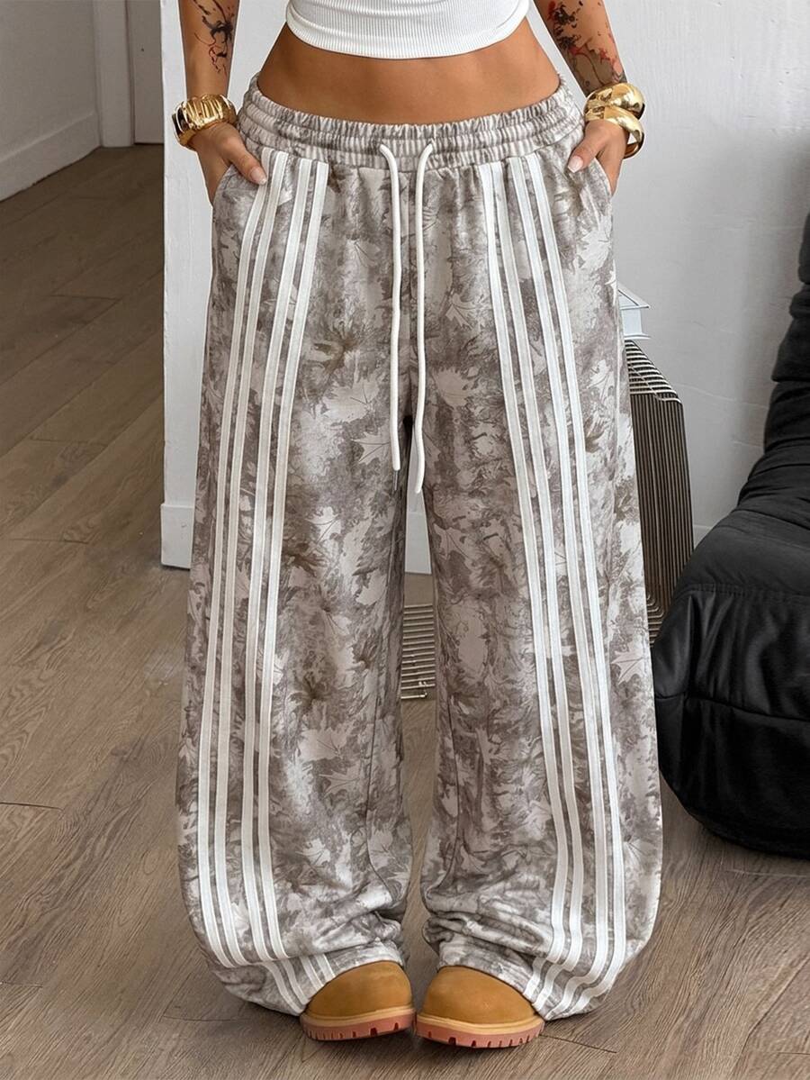 Women's loose fit wide leg graphic sweatpants in light grey with an elastic drawstring waistband