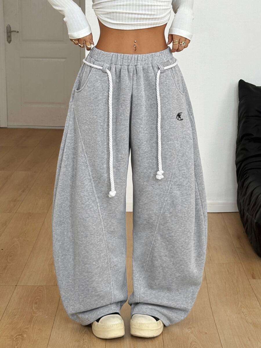 Women's casual grey plaid sweatpants featuring an elastic drawstring waistband, side pockets, and a relaxed loose fit.