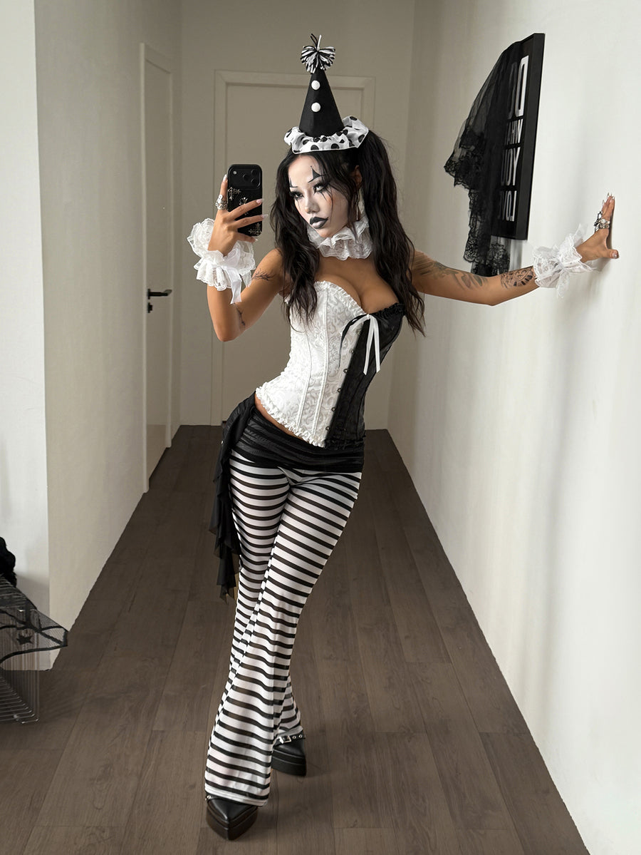 Women's black and white polka dot flare leg pants with side drawstring and ruched details