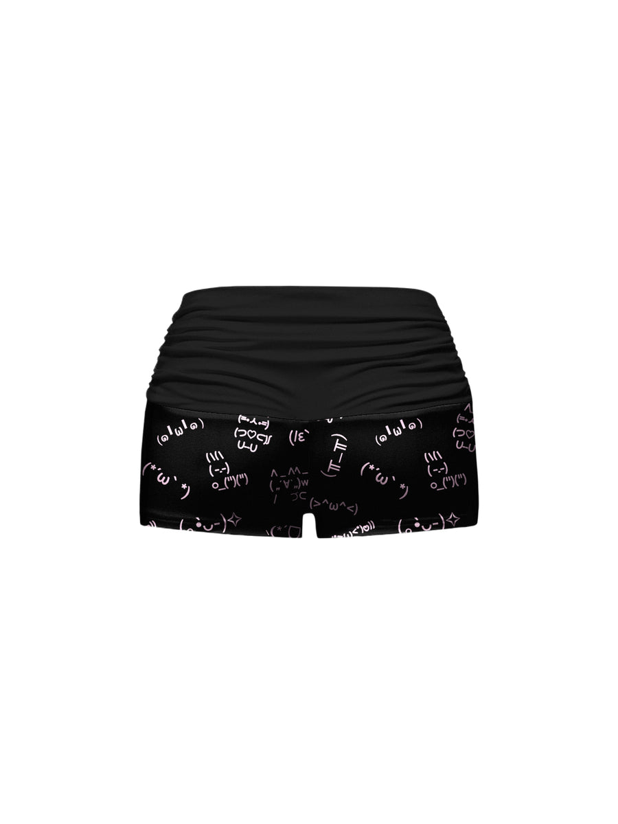Black two-piece pajama set featuring a spaghetti strap backless camisole and matching ruched shorts.