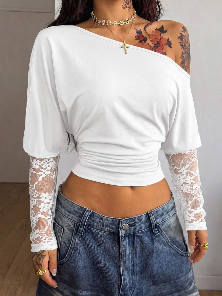Women's black long sleeve t-shirt featuring delicate contrast lace details and a boat neckline in a knitted stretch fabric.