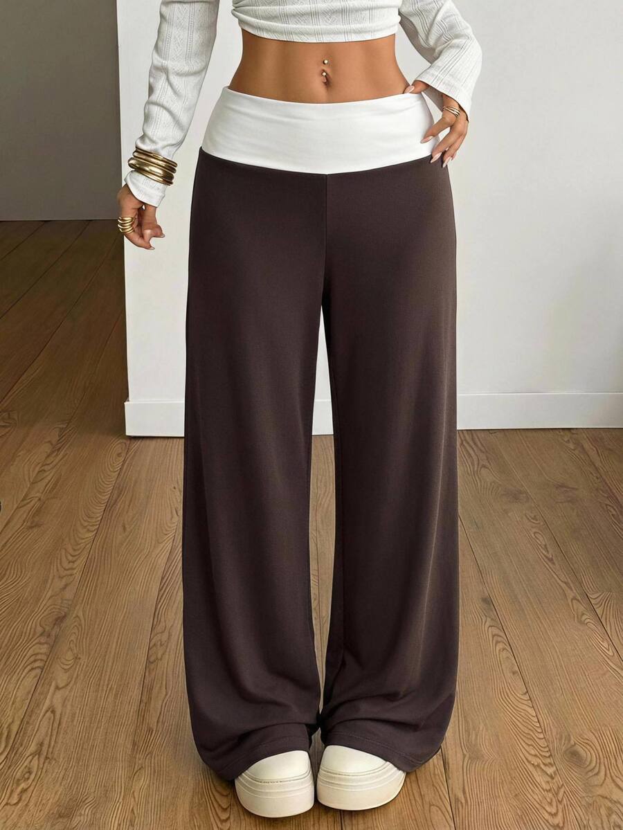 Women's casual straight leg sweatpants featuring a black and white polka dot design with an elastic waistband.