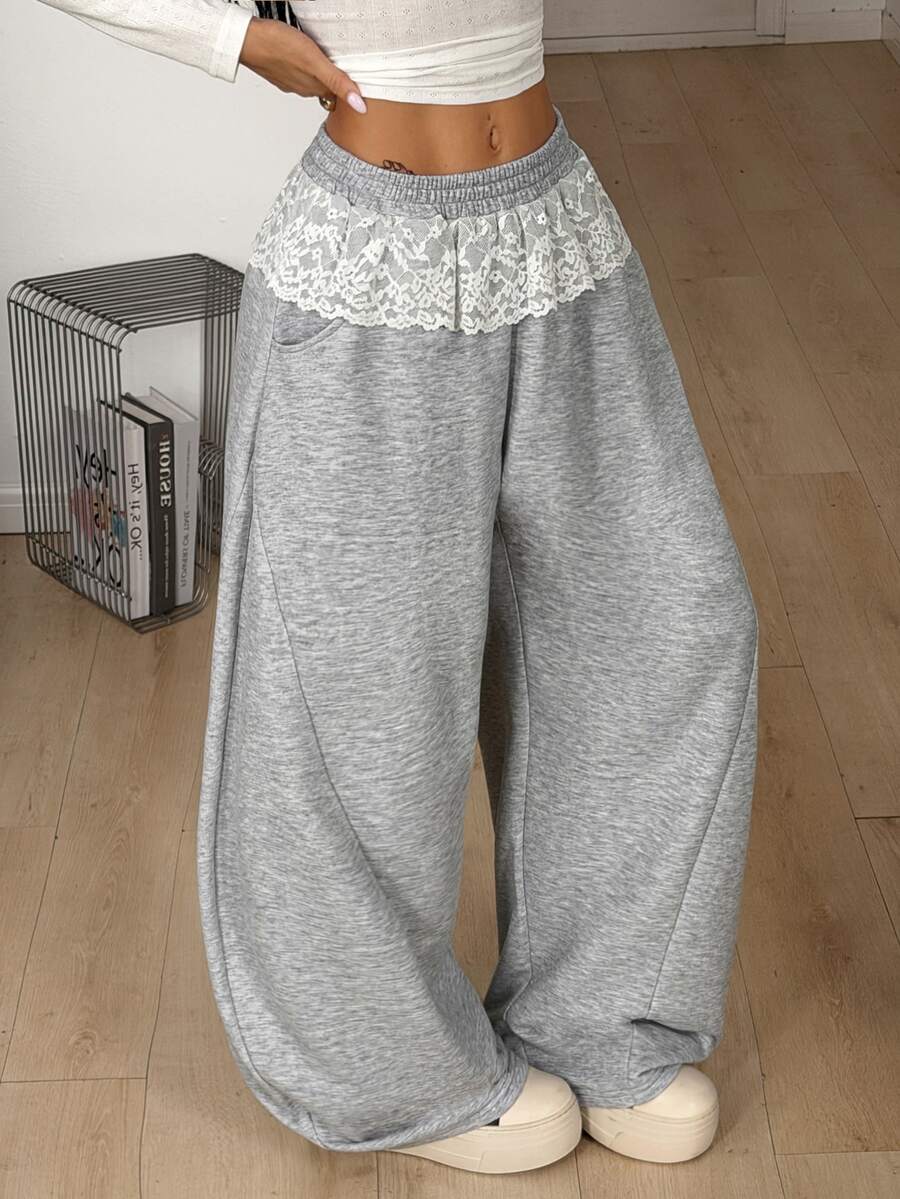 Women's casual grey plaid sweatpants featuring an elastic drawstring waistband, side pockets, and a relaxed loose fit.