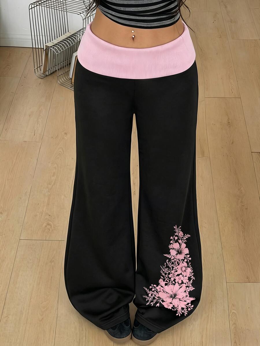 Women's black low waist wide leg flare sweatpants with rib-knit texture and contrast binding details.