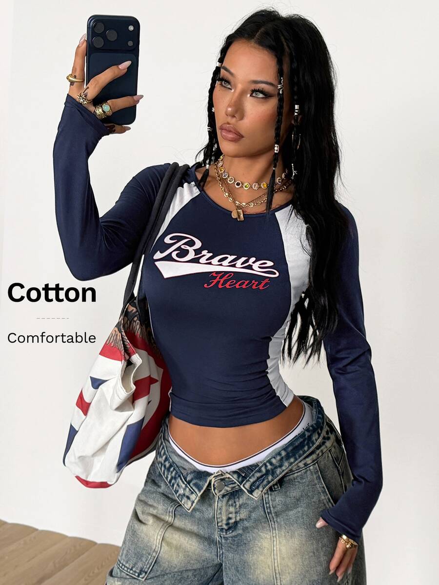Women's slim fit long sleeve raglan t-shirt with collegiate letter graphic print, round neck, and contrast binding.