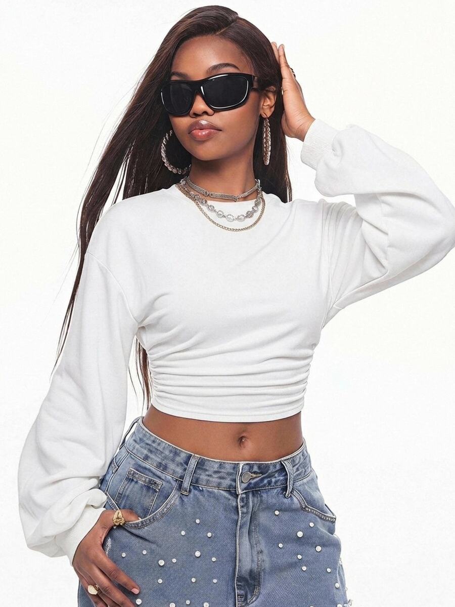 Women's casual black long sleeve knitted pullover sweatshirt featuring a round neck and cinched waist design.