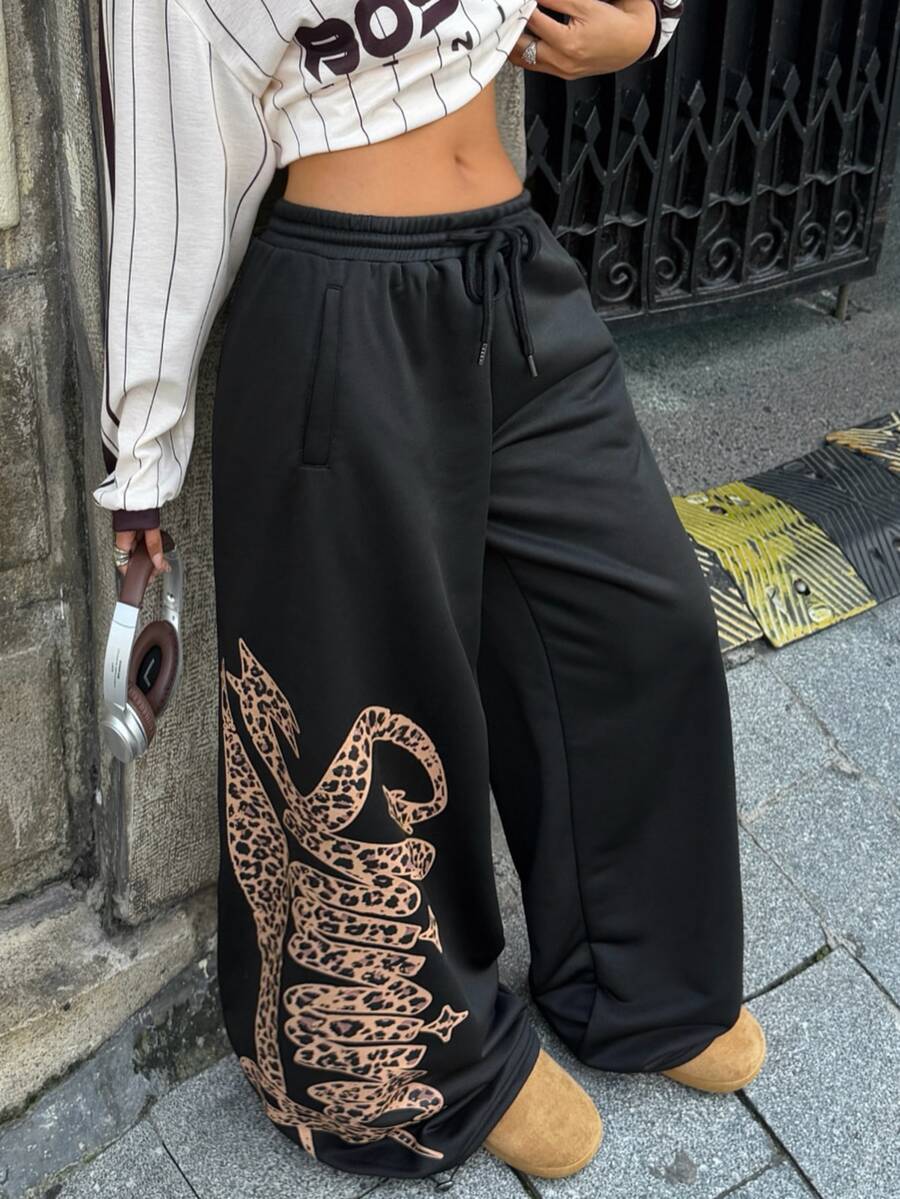 Women's loose fit wide leg graphic sweatpants in light grey with an elastic drawstring waistband