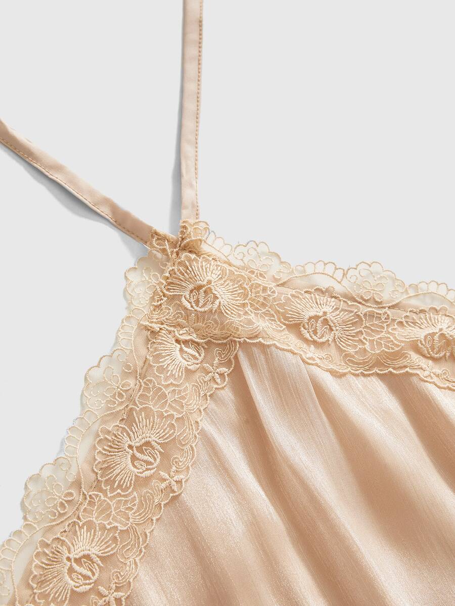 Front and back view of a women's halter neck sleeveless mini dress with contrast lace patchwork, tie knot backless detail, and layered ruffle hem.