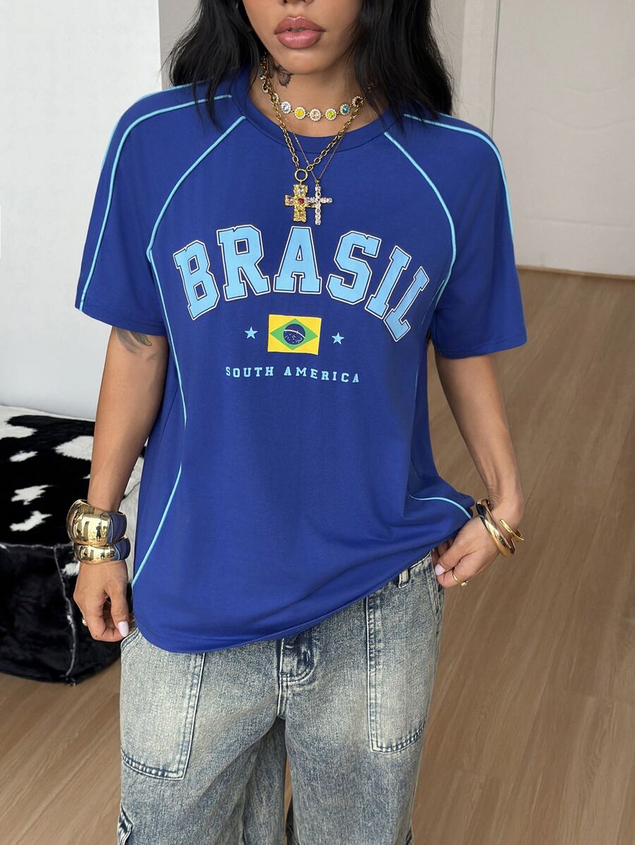 Yellow oversized graphic t-shirt featuring Brazil letter print on the front with contrast raglan sleeves and side stripe detailing.