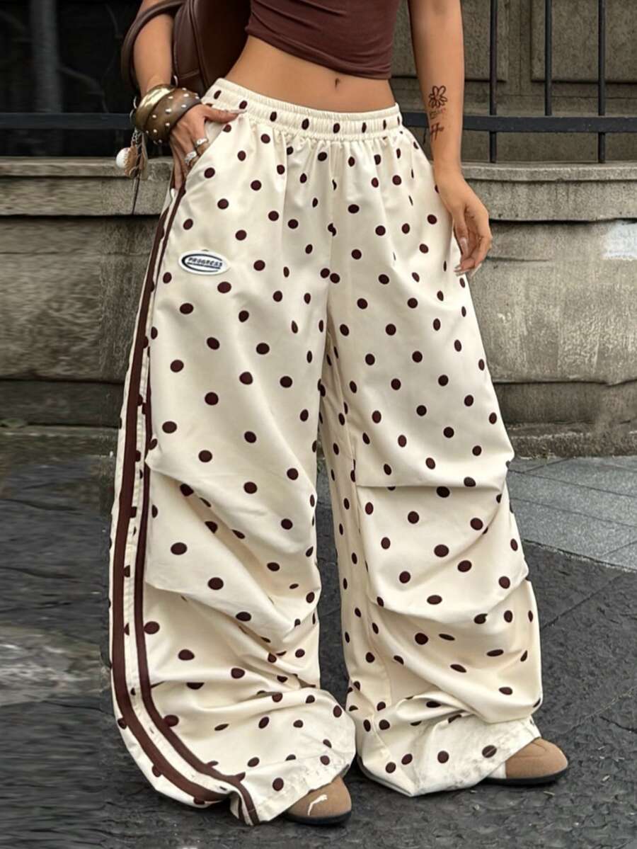 Women's black and white striped wide leg pants featuring an elastic drawstring waistband, side pockets, and a loose straight leg fit.