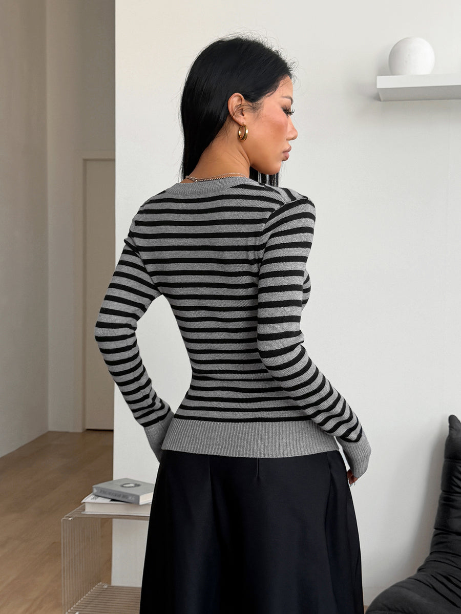 Women's slim fit cable-knit sweater with a V-neckline and long sleeves in solid green rib knit fabric.