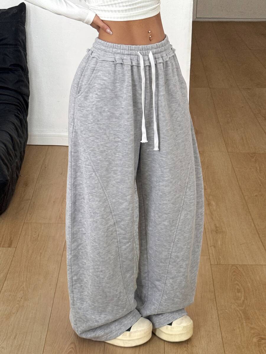 Women's casual grey plaid sweatpants featuring an elastic drawstring waistband, side pockets, and a relaxed loose fit.