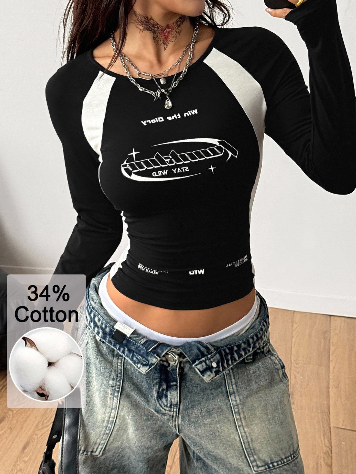 Women's plus size black and white colorblock long sleeve t-shirt with raglan sleeves and scoop neckline.