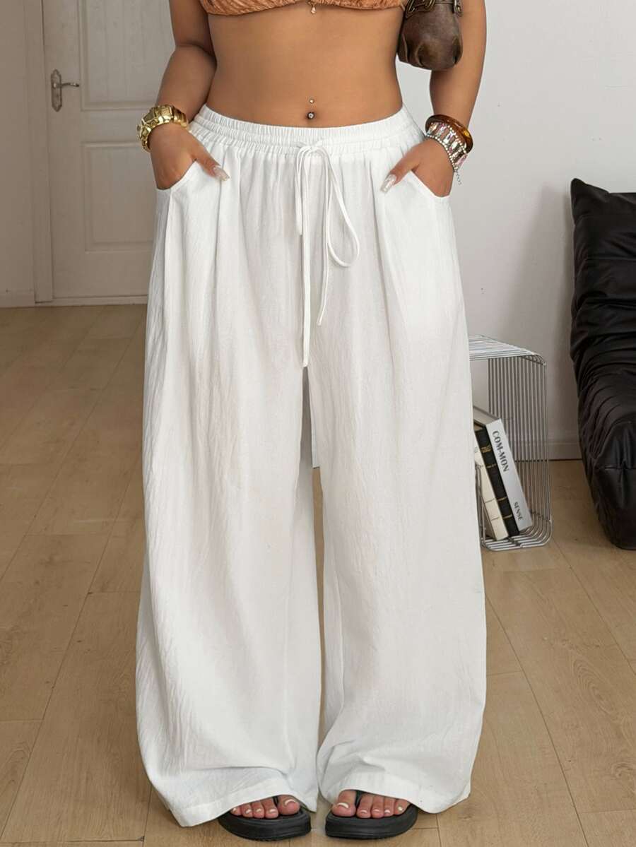Plus size women's striped loose straight leg cropped pants with pleated detailing and side pockets