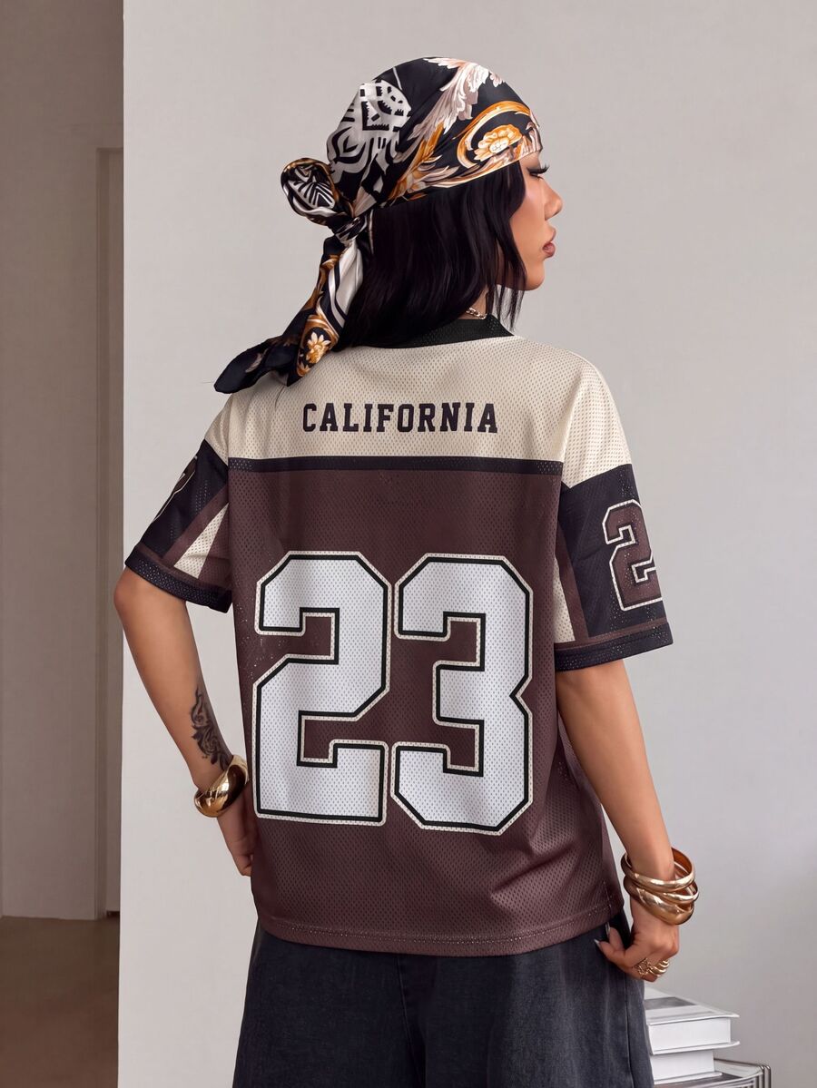 Women's oversized short sleeve graphic T-shirt with vintage digital geometric print, V-neck, and asymmetrical hem