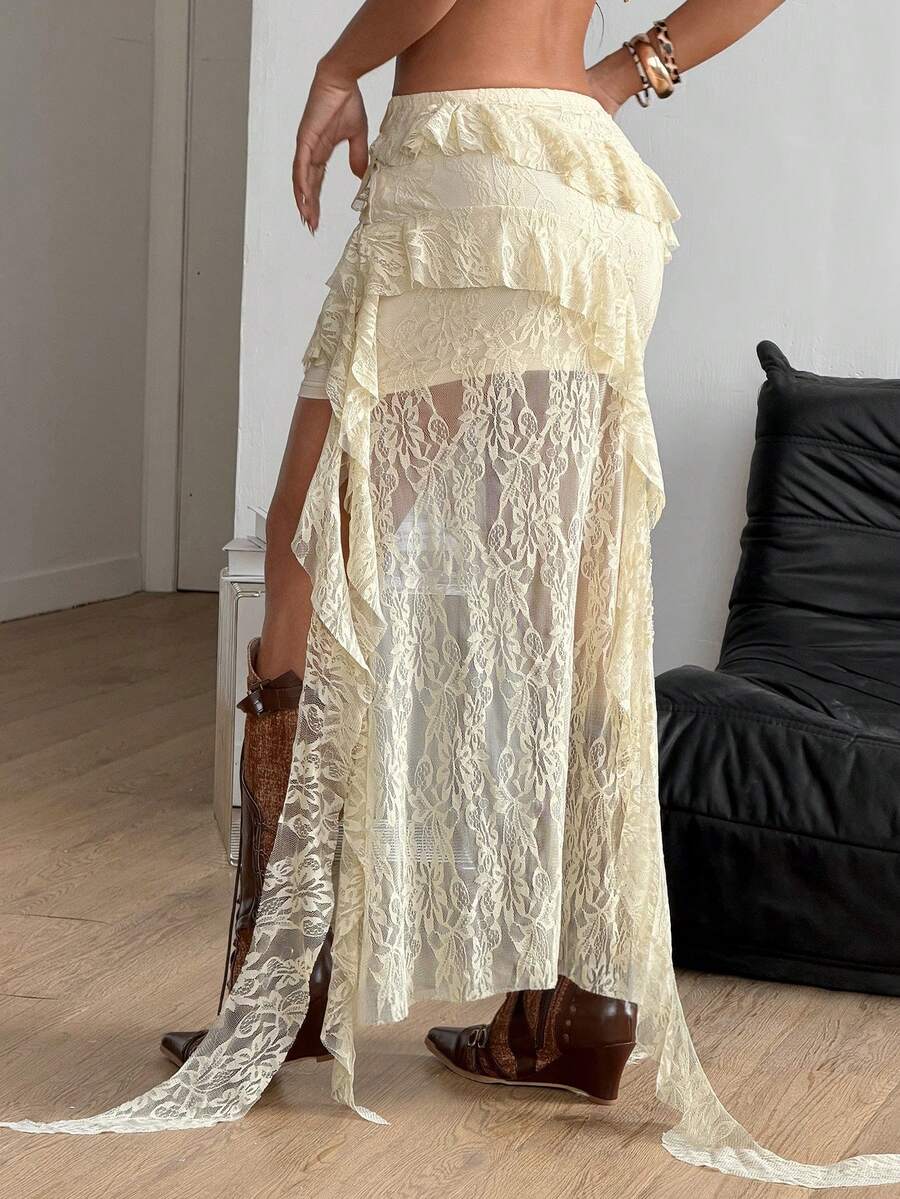 Women's low rise asymmetrical long skirt with ruffle hem detailing in semi-sheer knitted fabric.