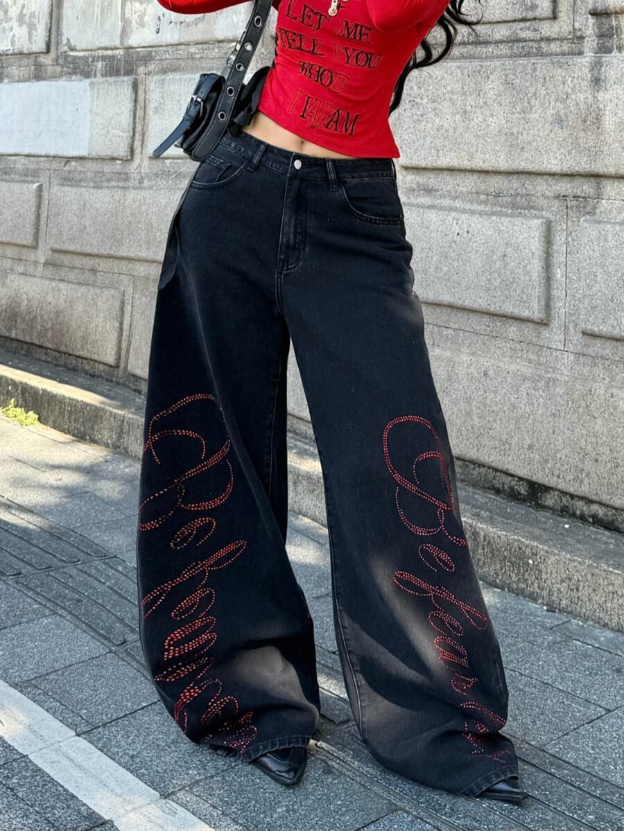 Front view of women's loose wide leg denim jeans featuring a mid waist, classic front pockets, and a zipper fly closure.