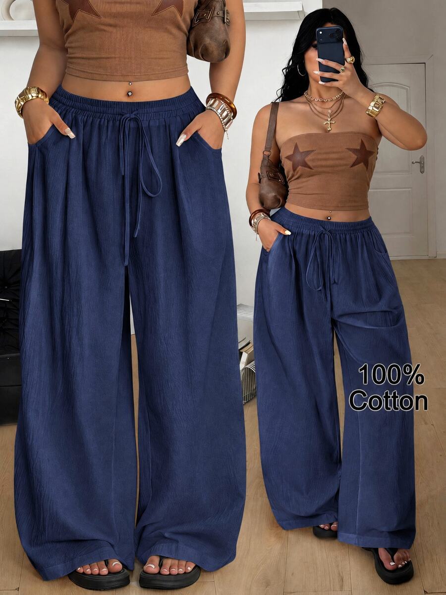 Plus size women's striped loose straight leg cropped pants with pleated detailing and side pockets