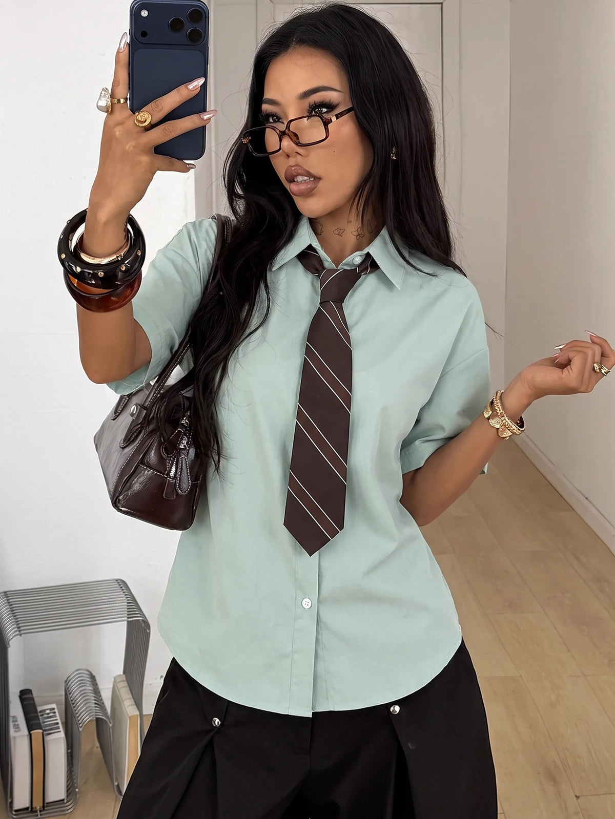 Women's casual button up shirt with half sleeves, classic shirt collar, and chest pocket in a woven fabric.