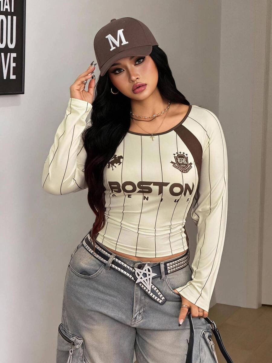 Women's plus size black and white colorblock long sleeve t-shirt with raglan sleeves and scoop neckline.