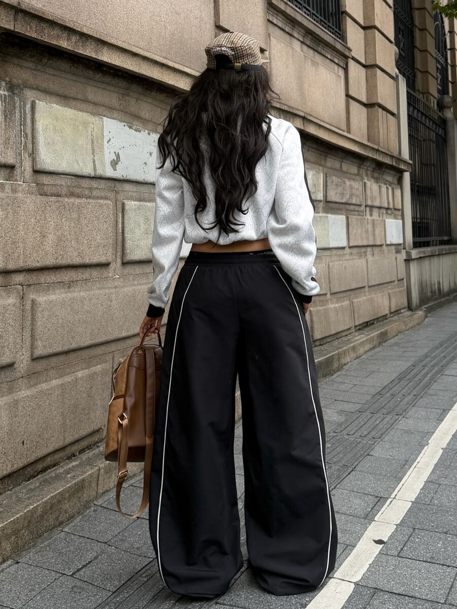 Women's loose fit straight leg pants in black and white with banded texture design, low drawstring waist, and pockets.