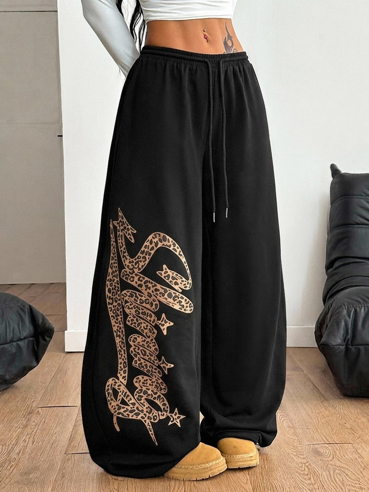 Women's loose fit wide leg graphic sweatpants in light grey with an elastic drawstring waistband