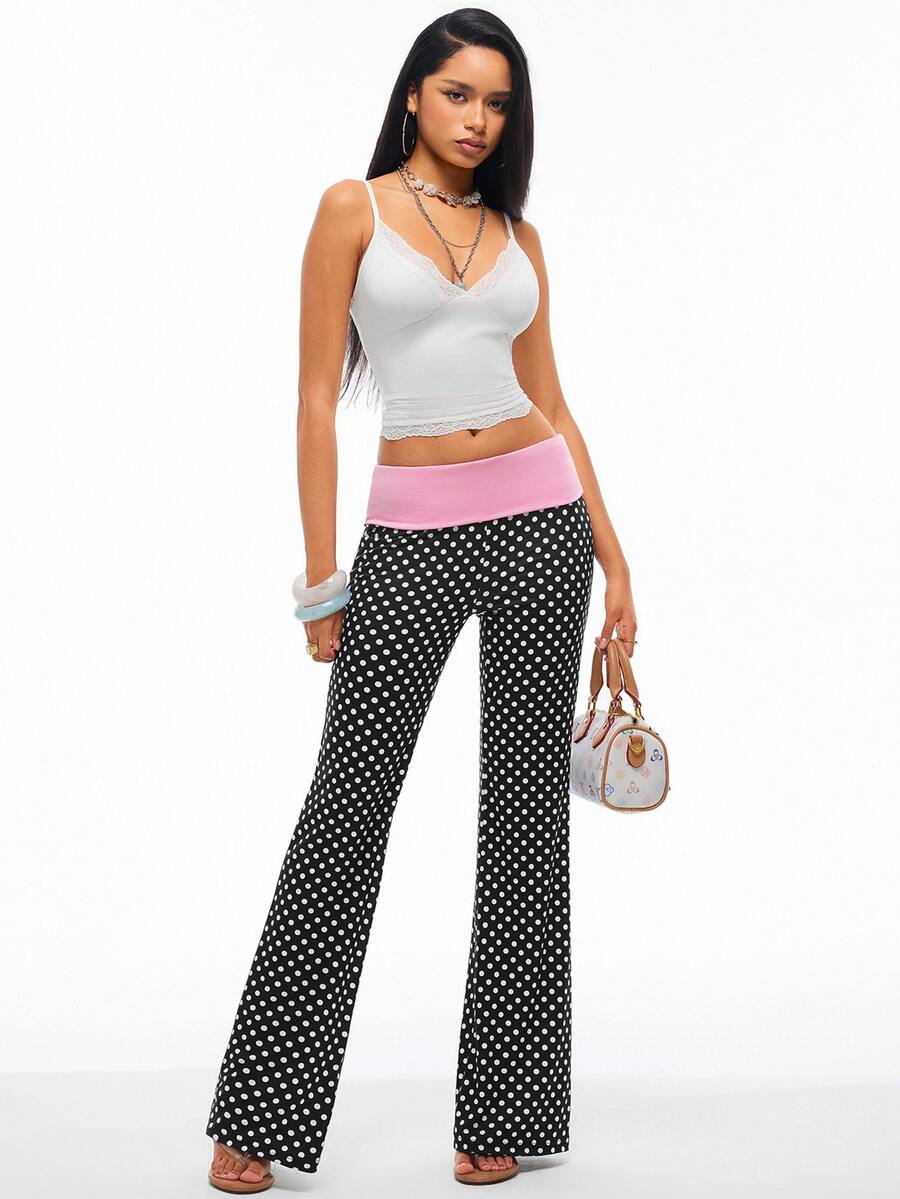 Women's black and white polka dot flare leg pants with side drawstring and ruched details