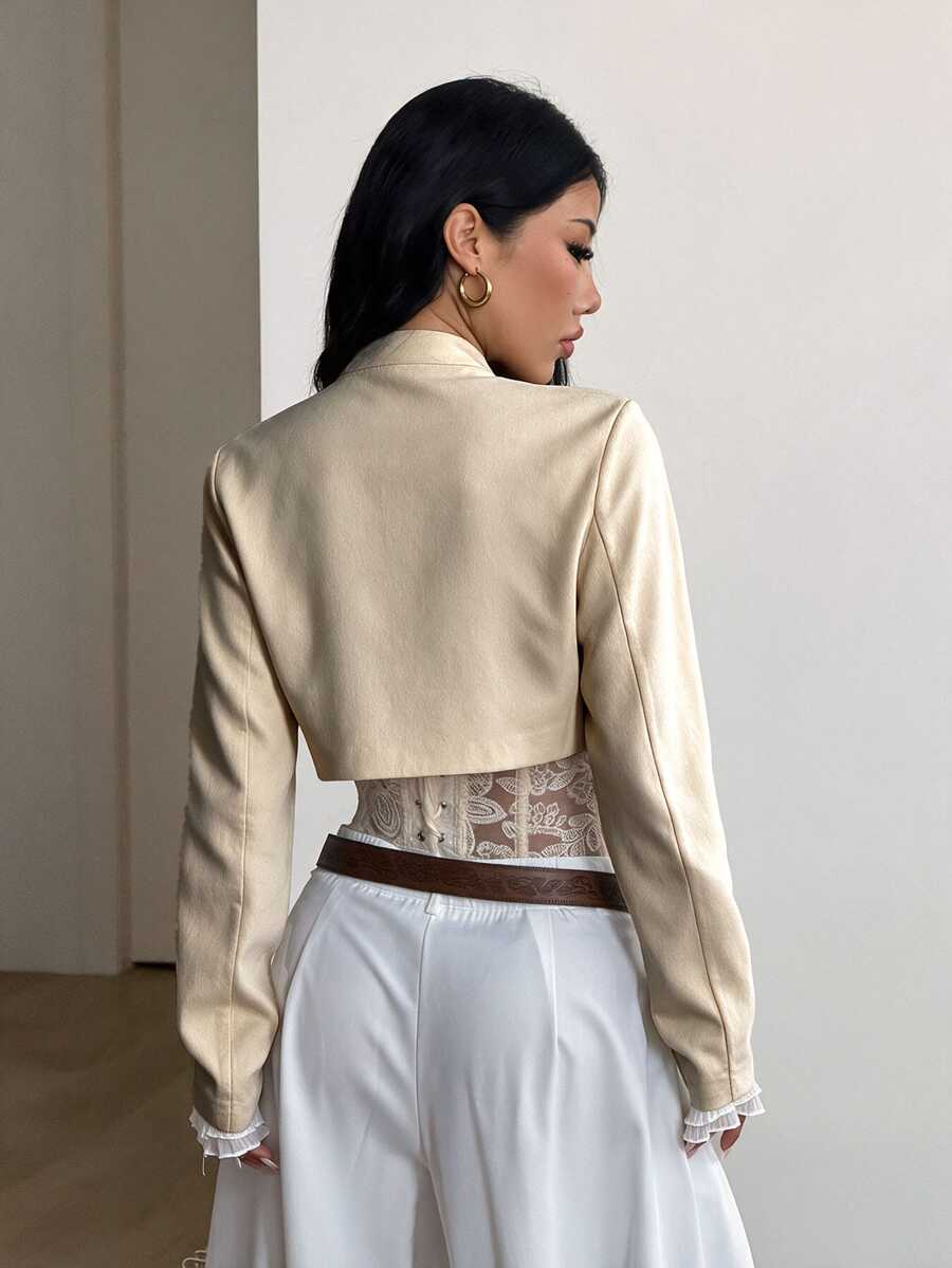 Women's metallic grey cropped faux leather jacket featuring a stand collar and asymmetrical zip front closure.