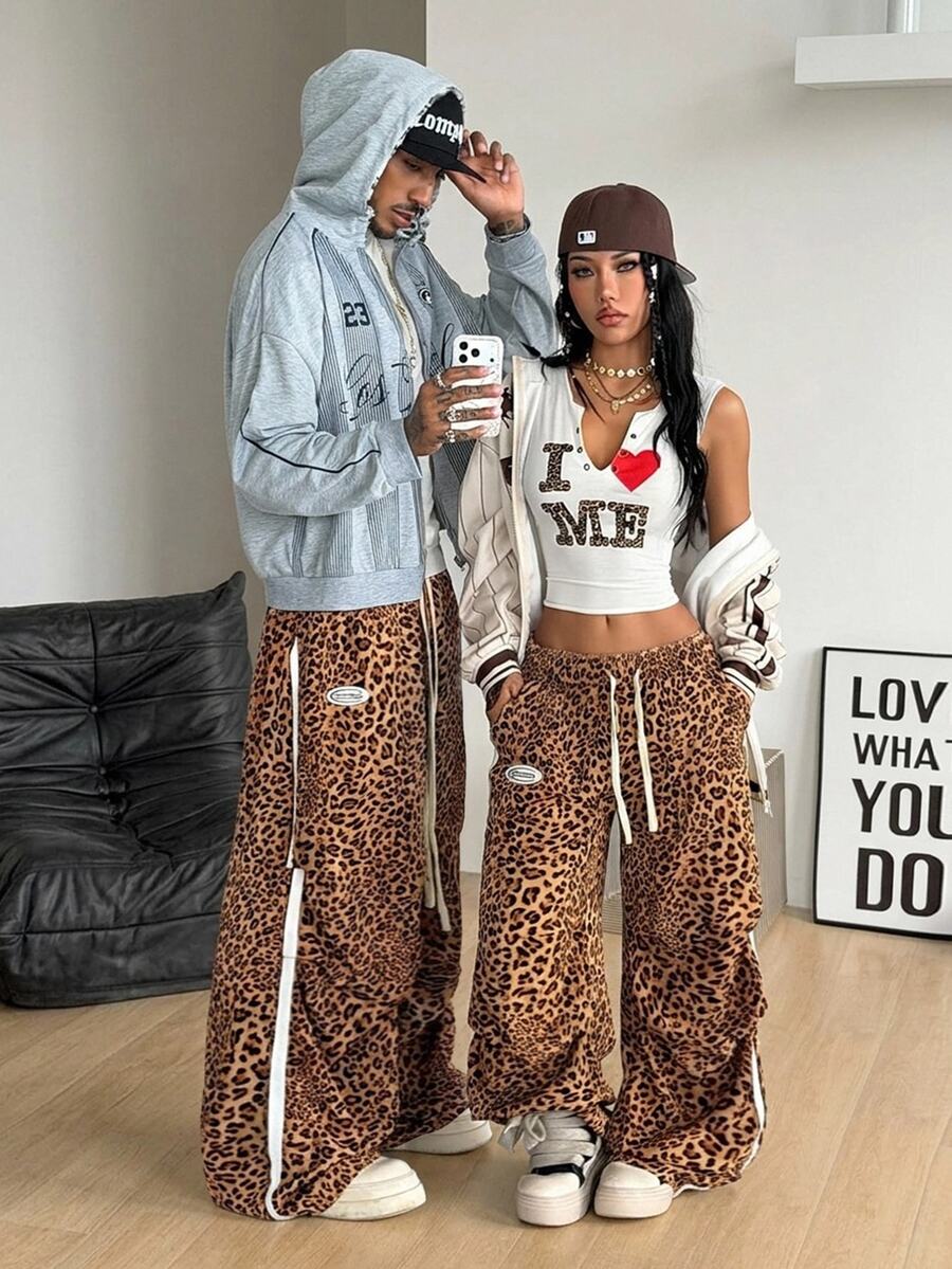Women's black and white striped wide leg pants featuring an elastic drawstring waistband, side pockets, and a loose straight leg fit.