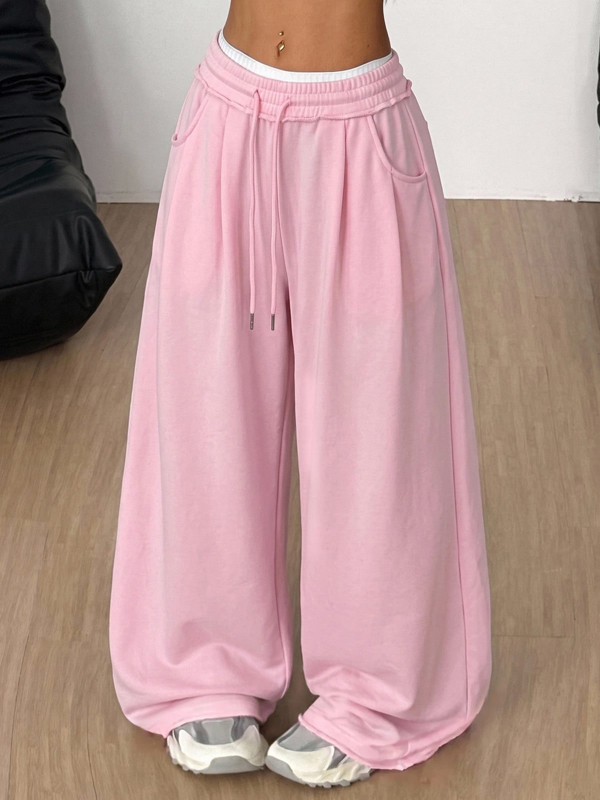 Women's casual straight leg baggy lounge pants in light grey with an adjustable drawstring waist and side pockets.