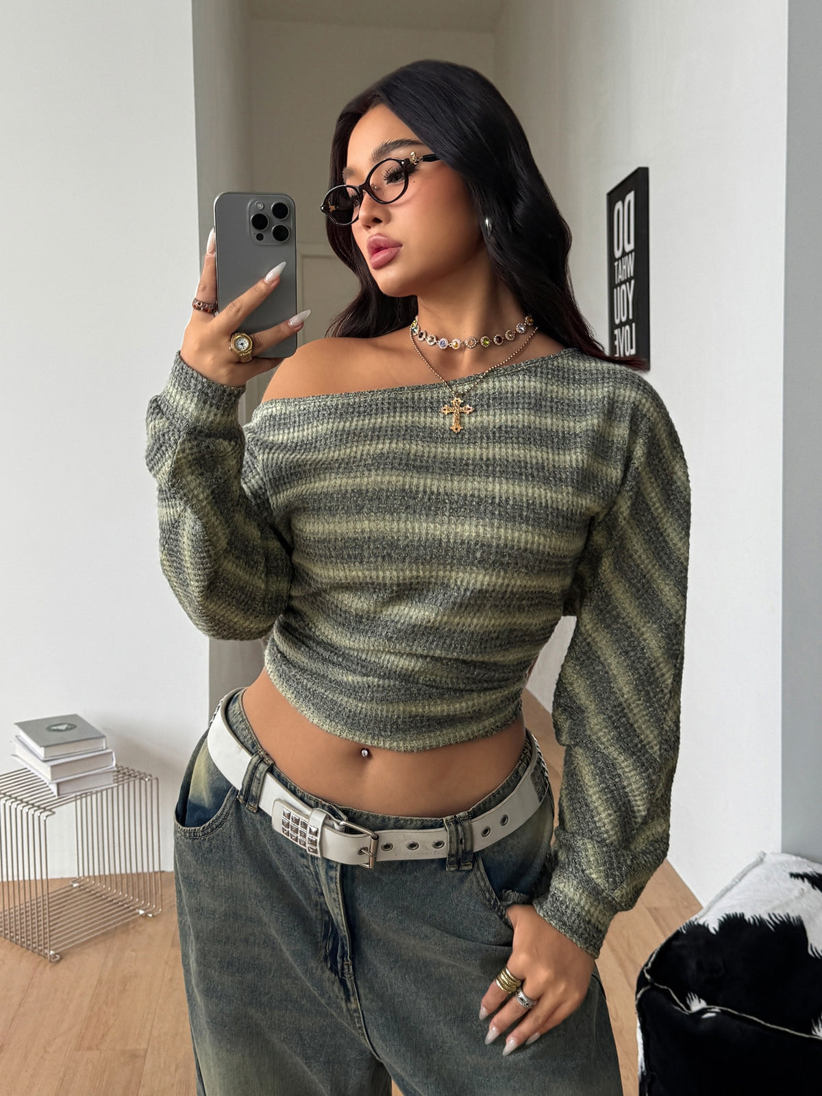 Plus size women's striped rib-knit long sleeve t-shirt featuring an asymmetrical neckline and ruched accents.