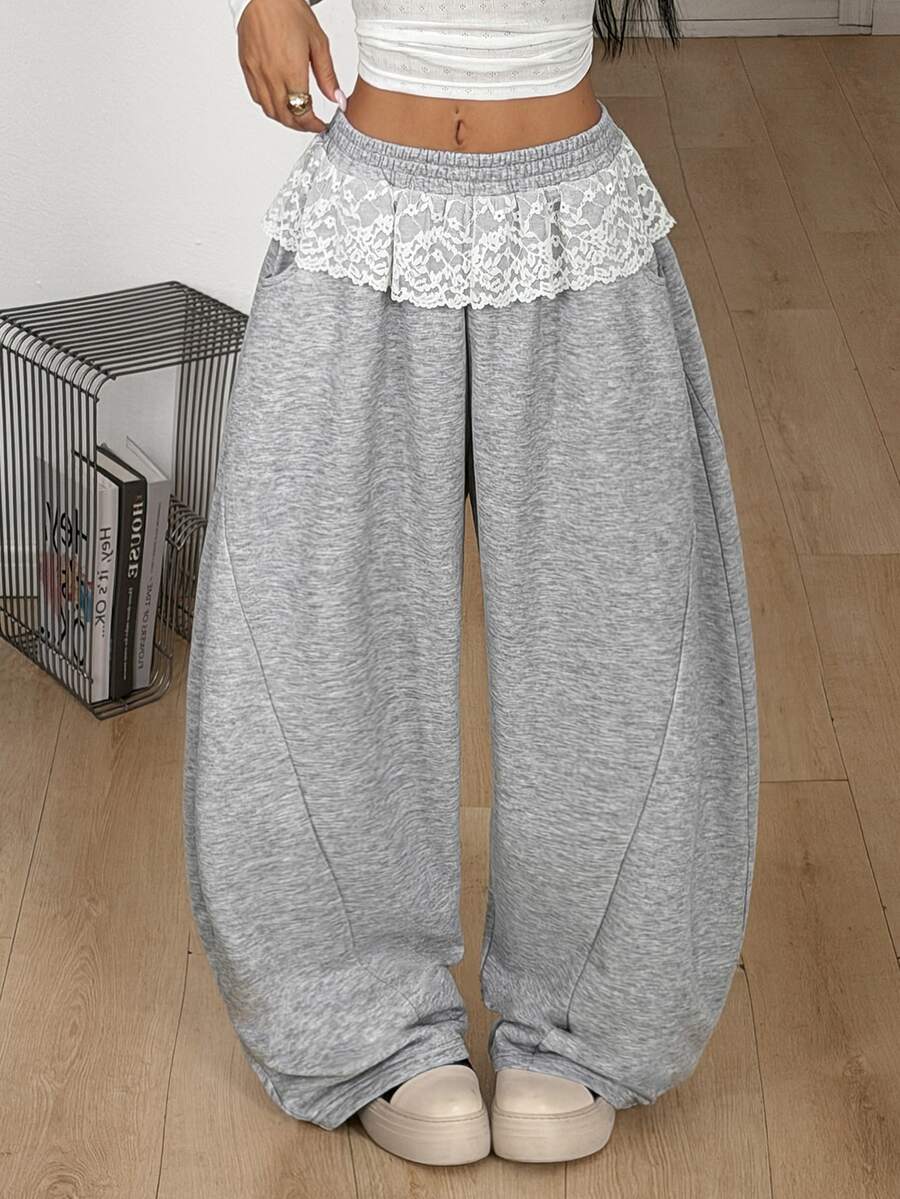 Women's casual grey plaid sweatpants featuring an elastic drawstring waistband, side pockets, and a relaxed loose fit.