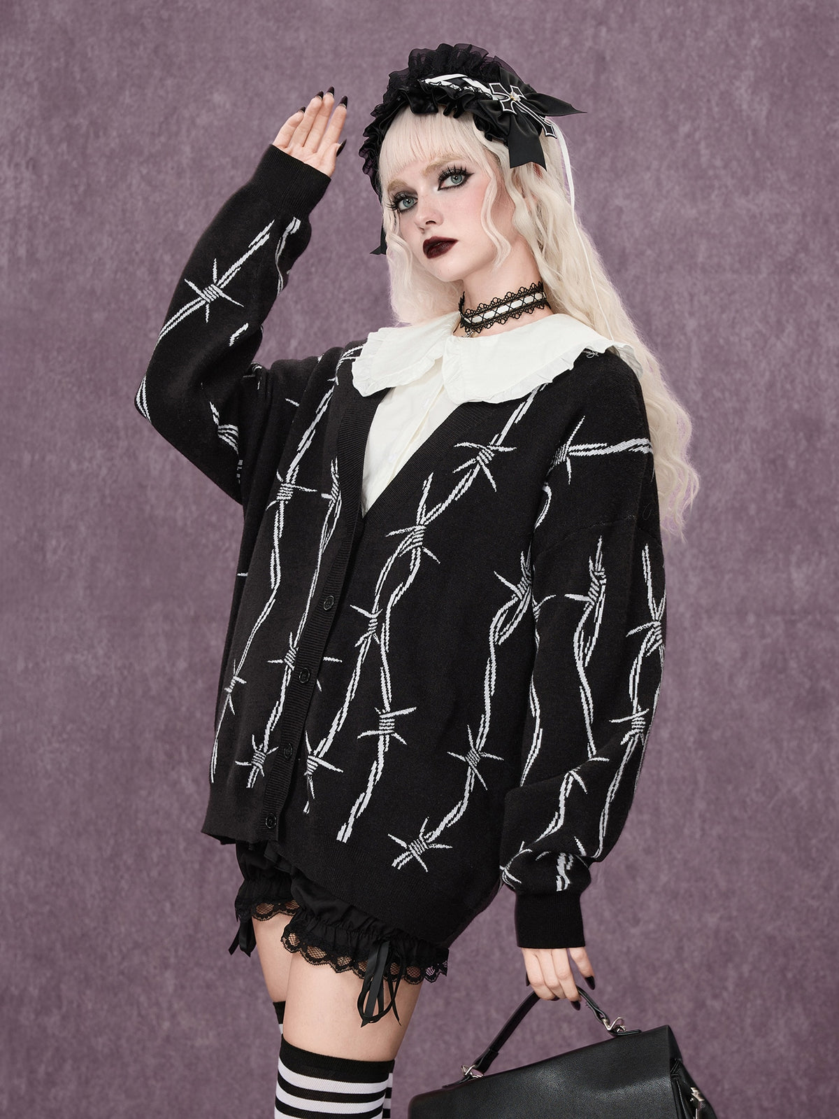 Women's oversized gothic thorn jacquard knit cardigan with V-neckline, button-front closure, and long drop-shoulder sleeves.
