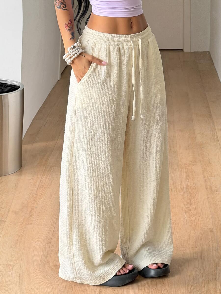 Women's loose fit straight leg lounge pants in textured knit fabric featuring an elastic drawstring waist and side pockets