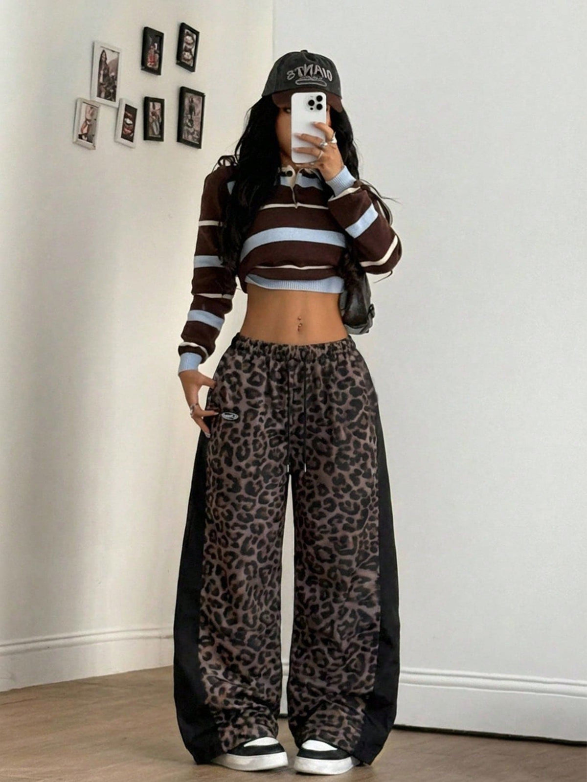 Women's black baggy jogger pants with an adjustable drawstring waist and colorblock polka dot geometric pattern.