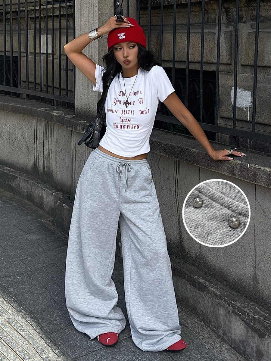 Women's loose fit wide leg graphic sweatpants in light grey with an elastic drawstring waistband