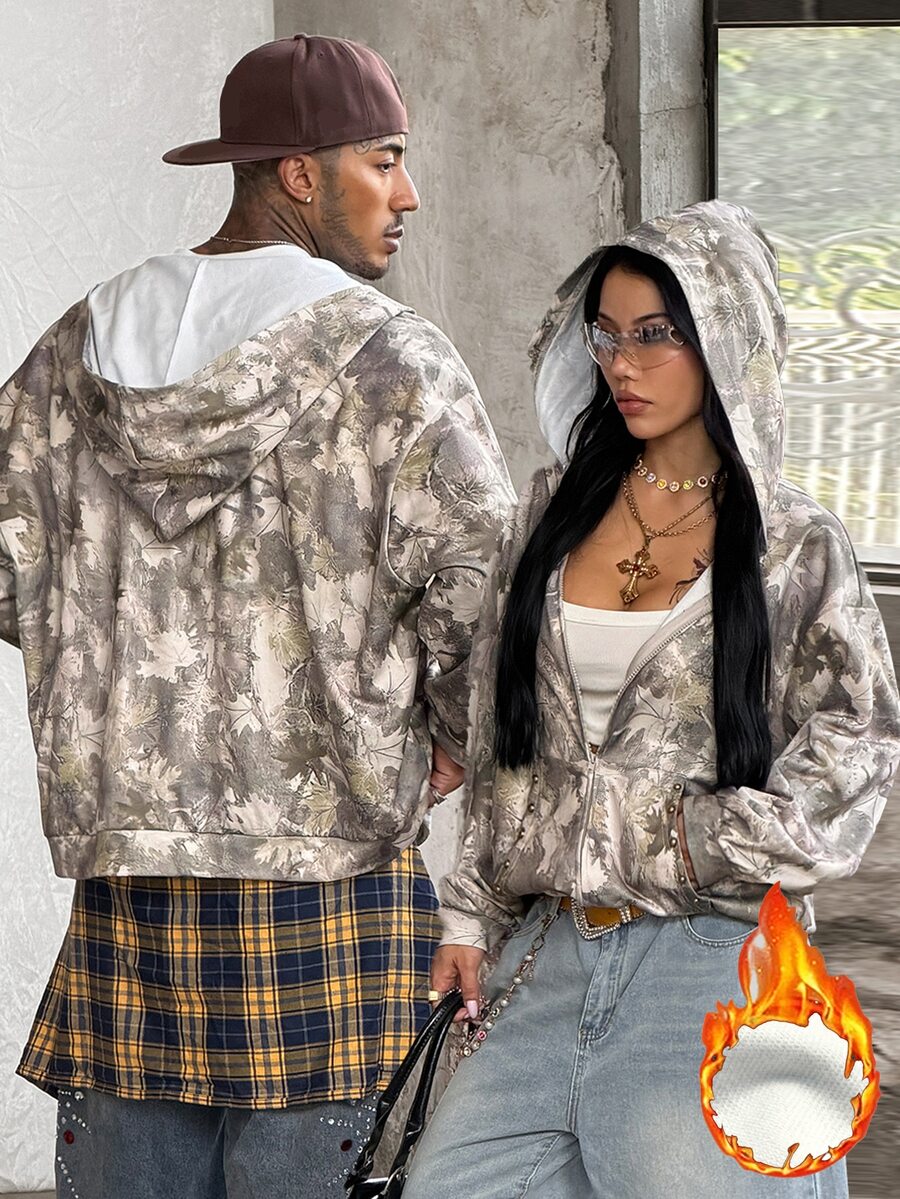 Women's army green camo zip up hoodie with drop shoulder sleeves, front pockets, and drawstring hood