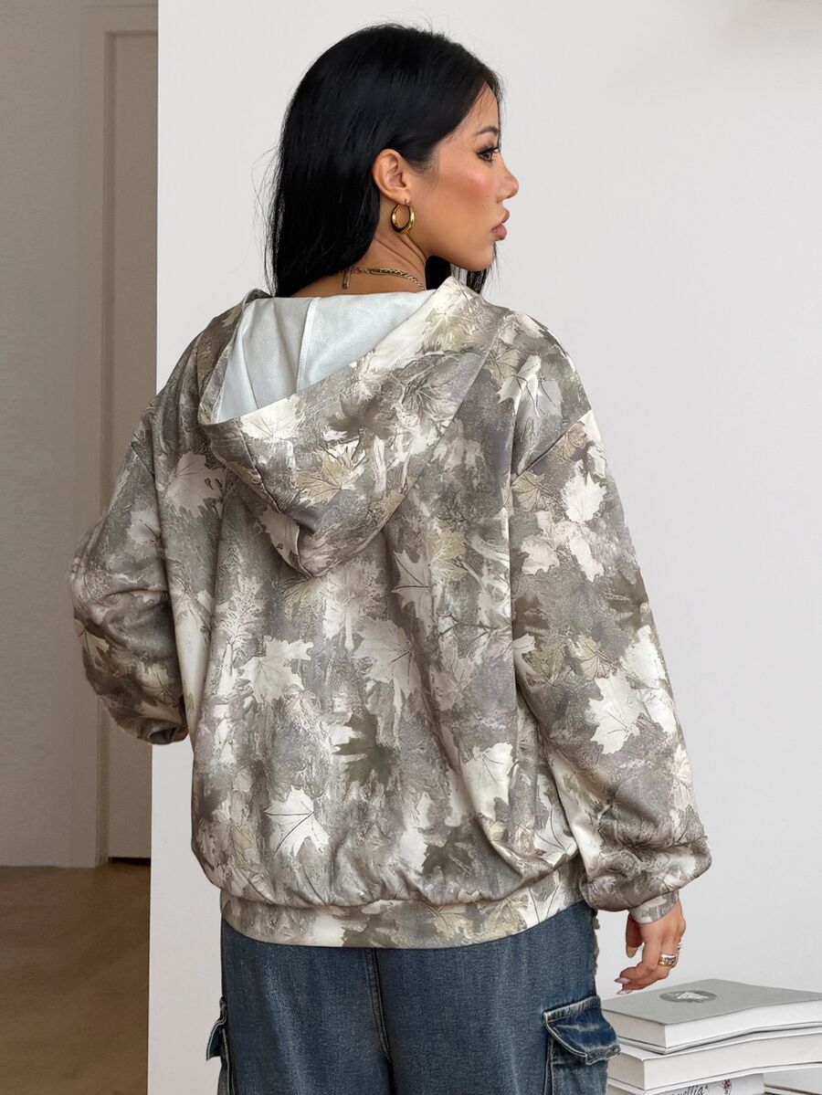 Women's army green camo zip up hoodie with drop shoulder sleeves, front pockets, and drawstring hood